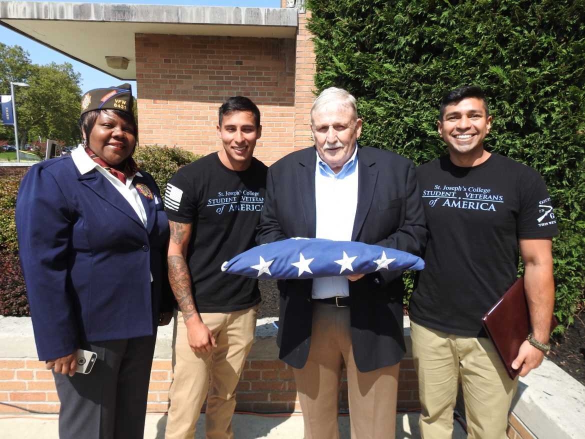 SJC Long Island student Veteran's of America students standing with service members.