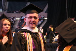 Male student in cap and gown. 