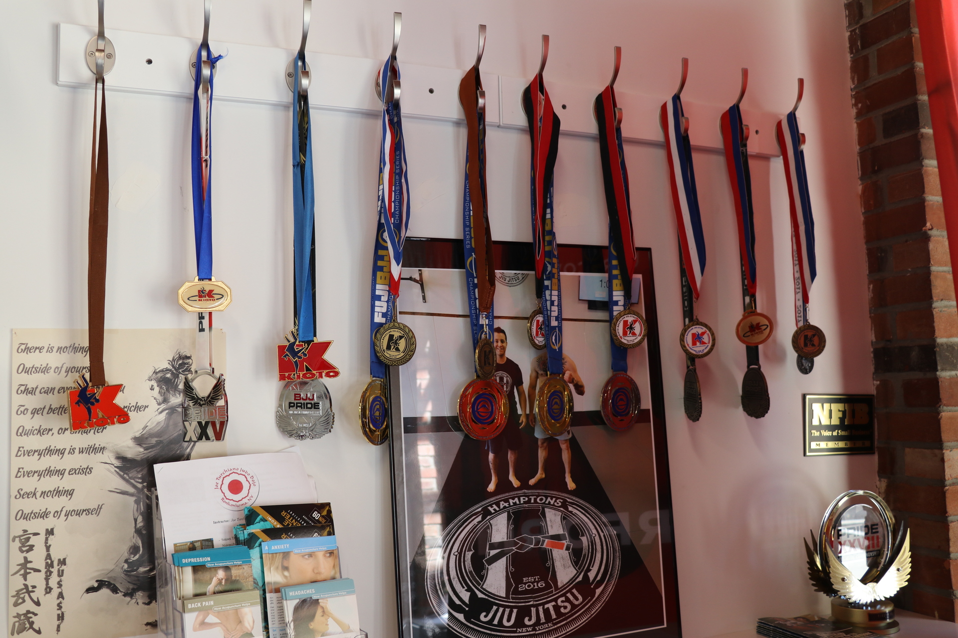 Greg's medals hanging up in Hamptons Jiu Jitsu.