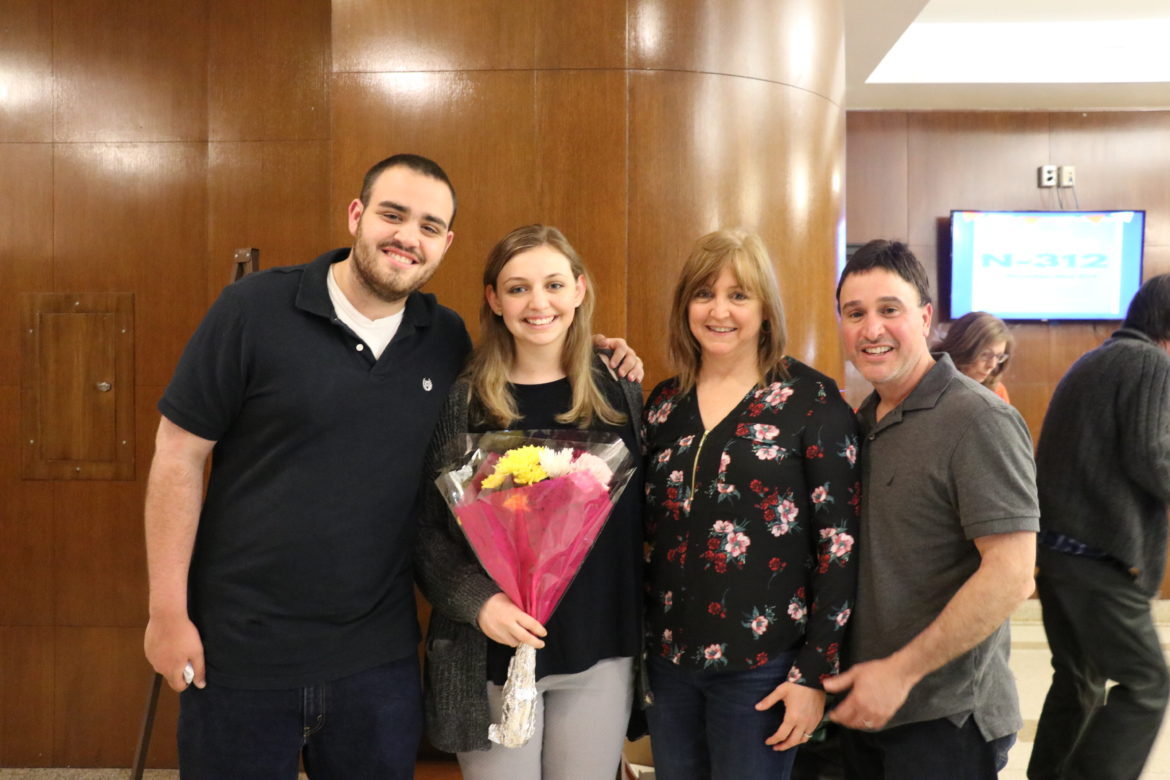 SJC Long Island student with her parents.
