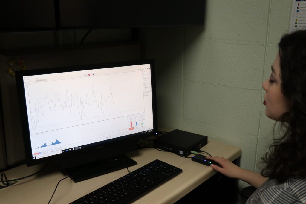 Sullivan conducting her research through a computer programming that studies heart rate.