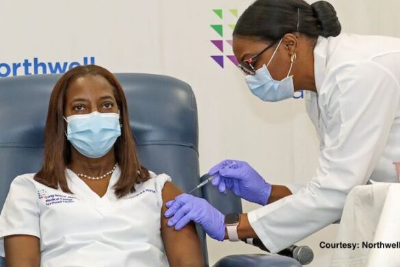 Nurse receiving vaccine shot.